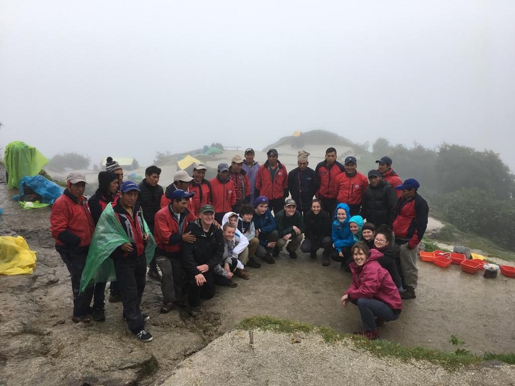 The group and the porter team at the Phuyupatamarca camp in cloud