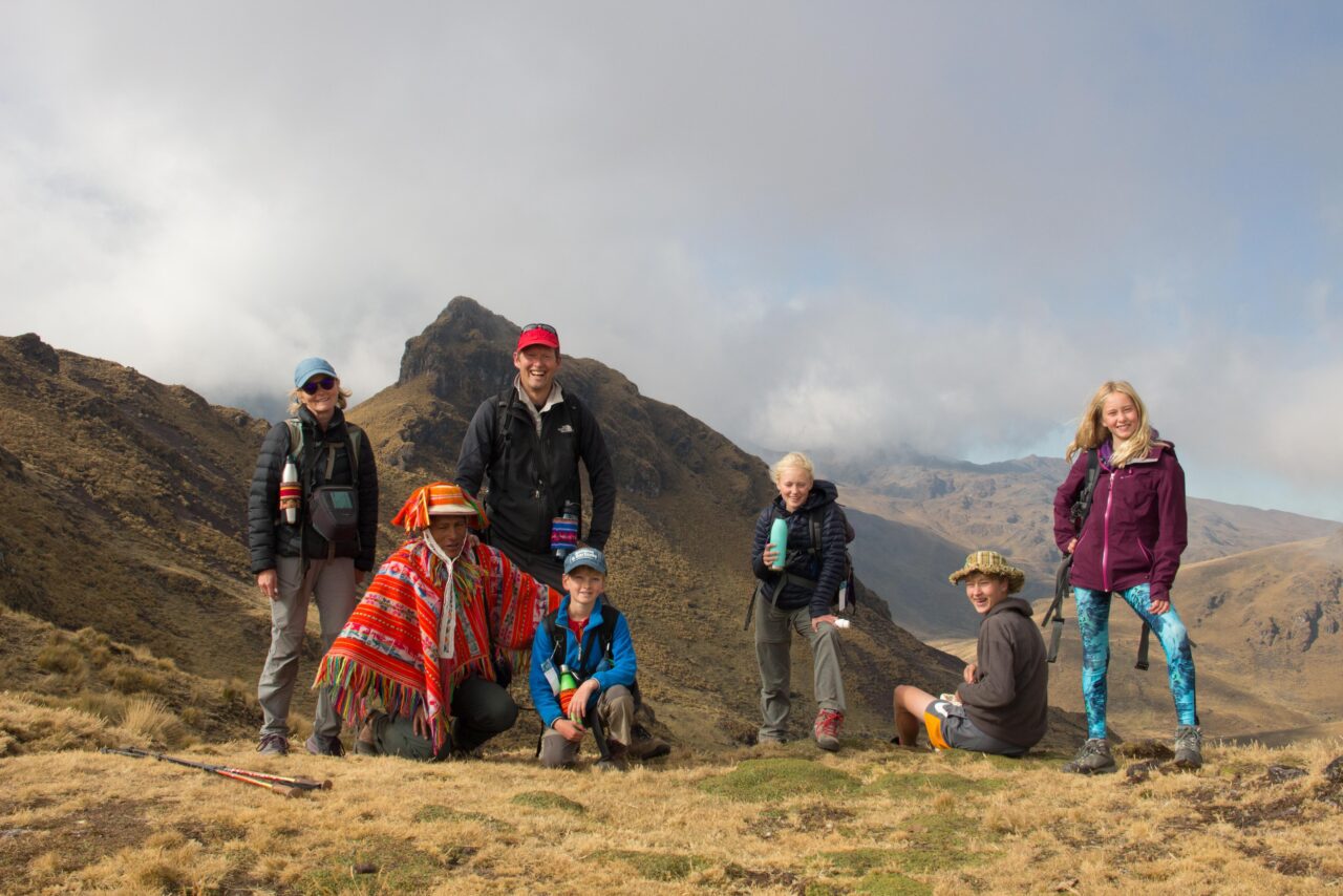 Travellers learning to weave with an Andean community